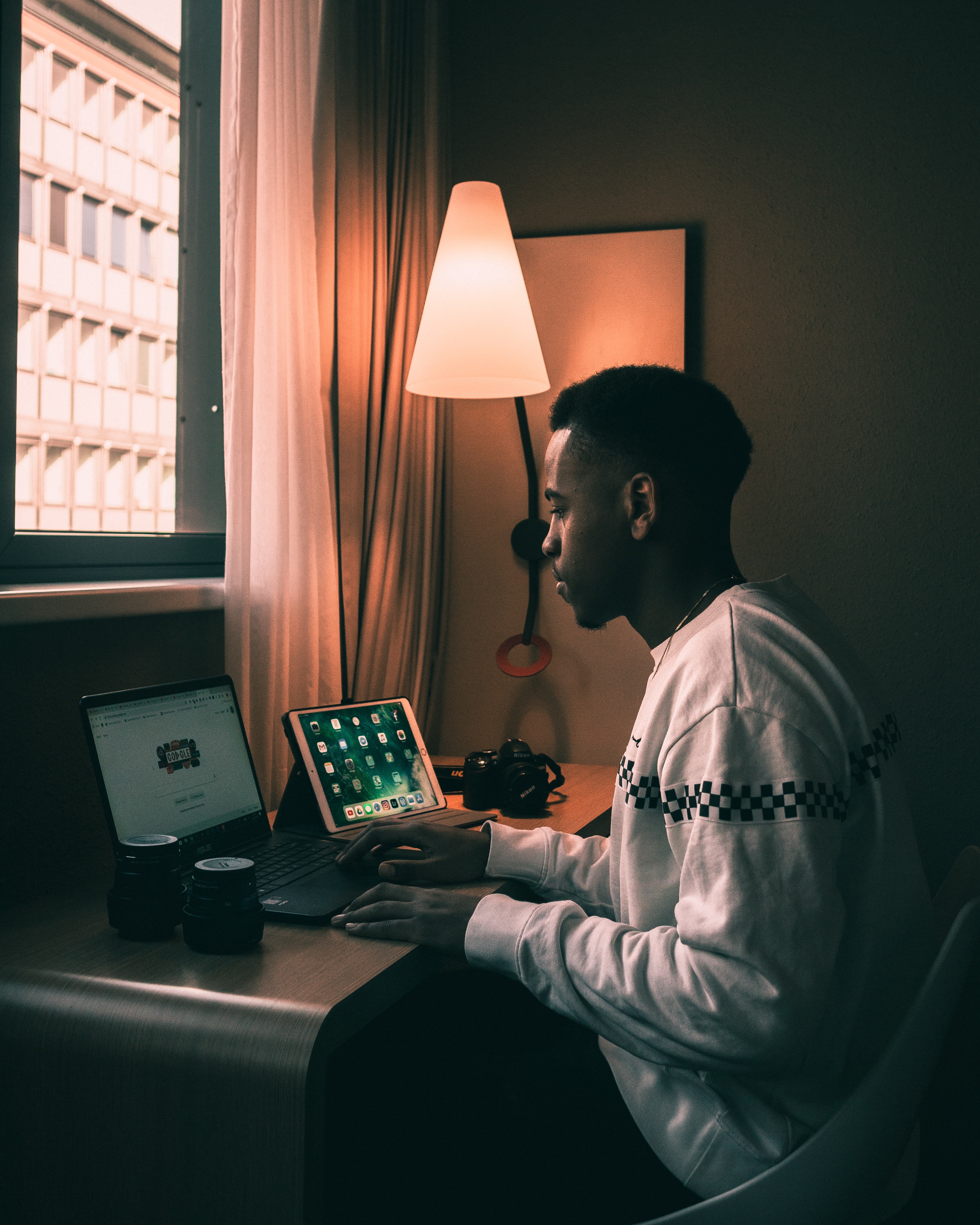 Man sitting by his desk using his computer